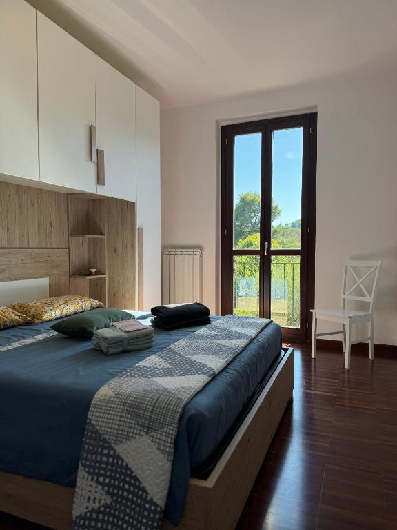 a bedroom with a large bed and a large window at Casa Numana Adamo ed Eva resort in Numana
