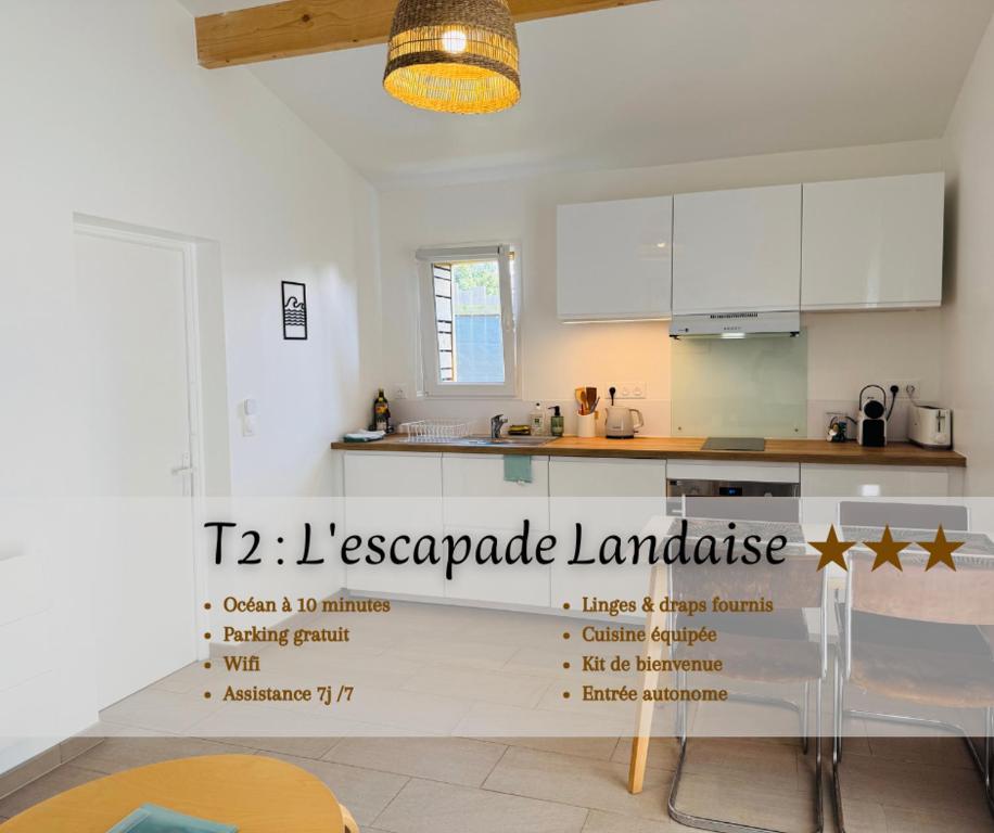 a kitchen with white cabinets and a sign that says pineapple laminate at L'escapade Landaise à 10 minutes des plages in Soustons