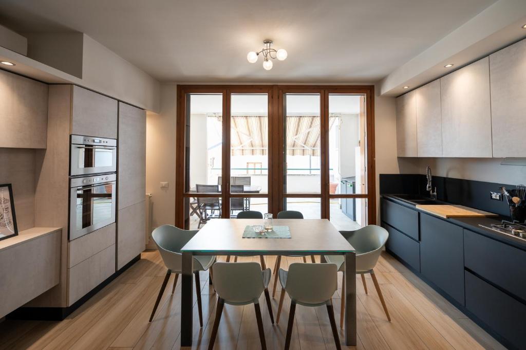 a kitchen with a dining room table and chairs at Italian Vacation Homes - Easy Living Iseo Lake in Predore