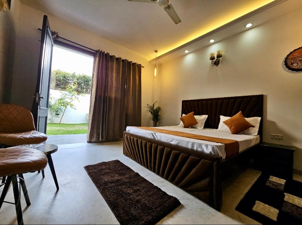 a bedroom with a large bed and a window at G-town living in Gurgaon