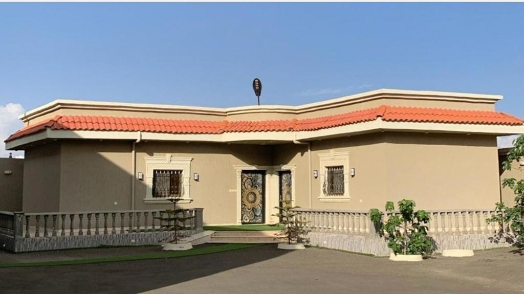 a small white house with a fence around it at راحتي in Al Baha