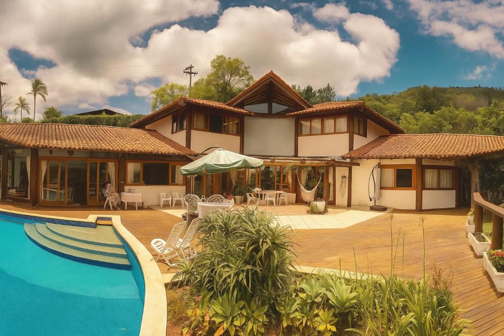 a house with a swimming pool in front of it at Suíte em Condomínio de Luxo em Casa de Família in Araras Petropolis