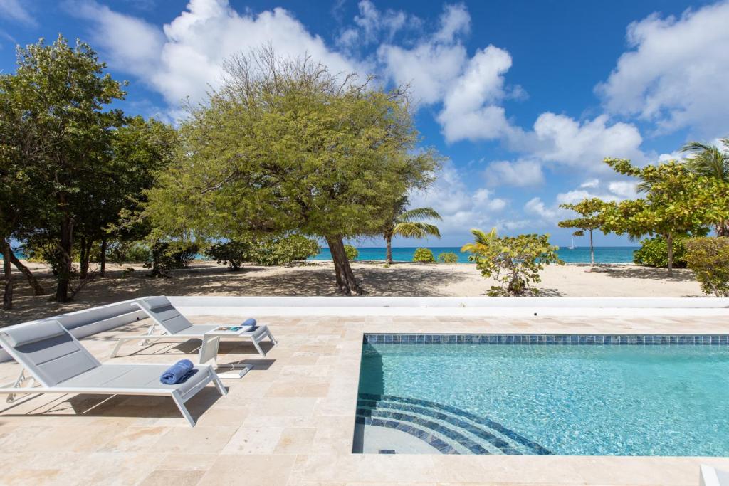 an image of a swimming pool at a villa at Blue Horizon Beach Bungalow in Baie Longue