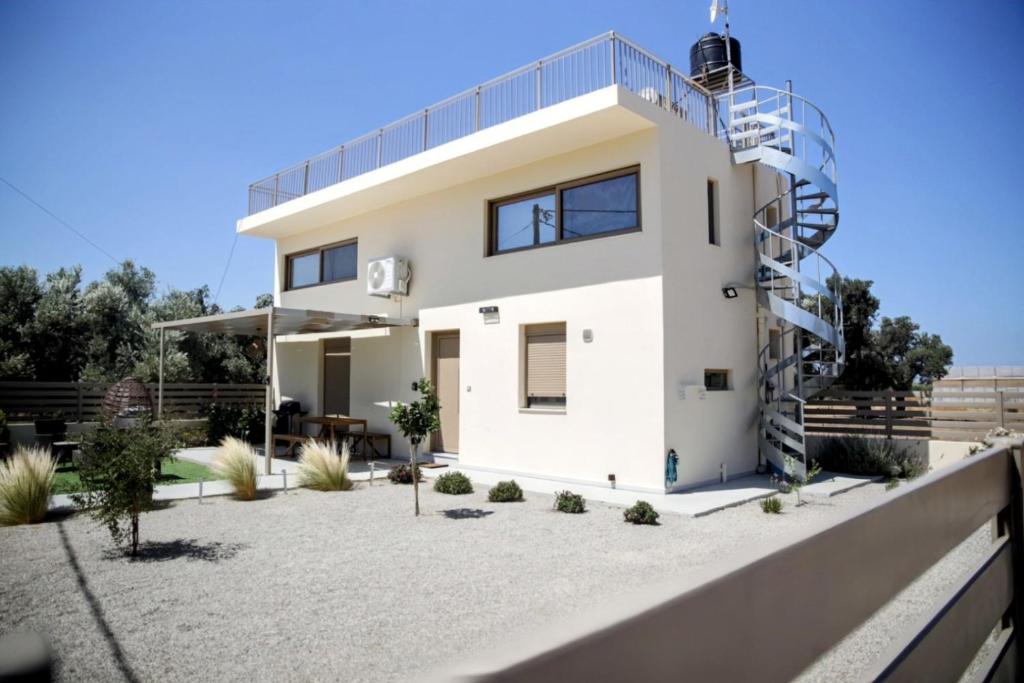 a white house with a spiral at LIVAS Residence in Tympáki