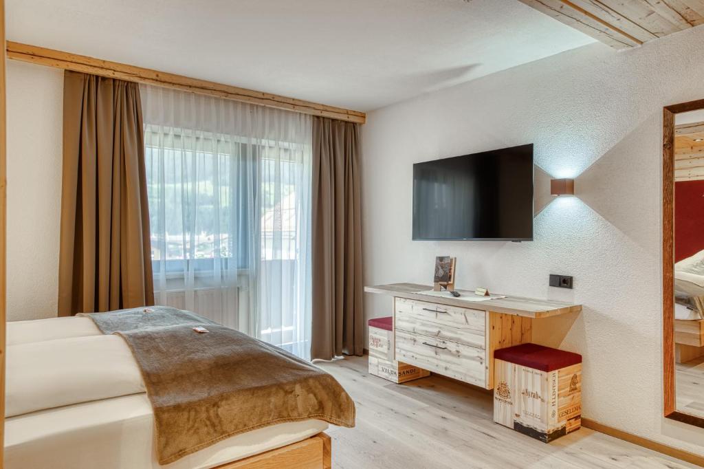 Postel nebo postele na pokoji v ubytování Hotel Alpenstolz