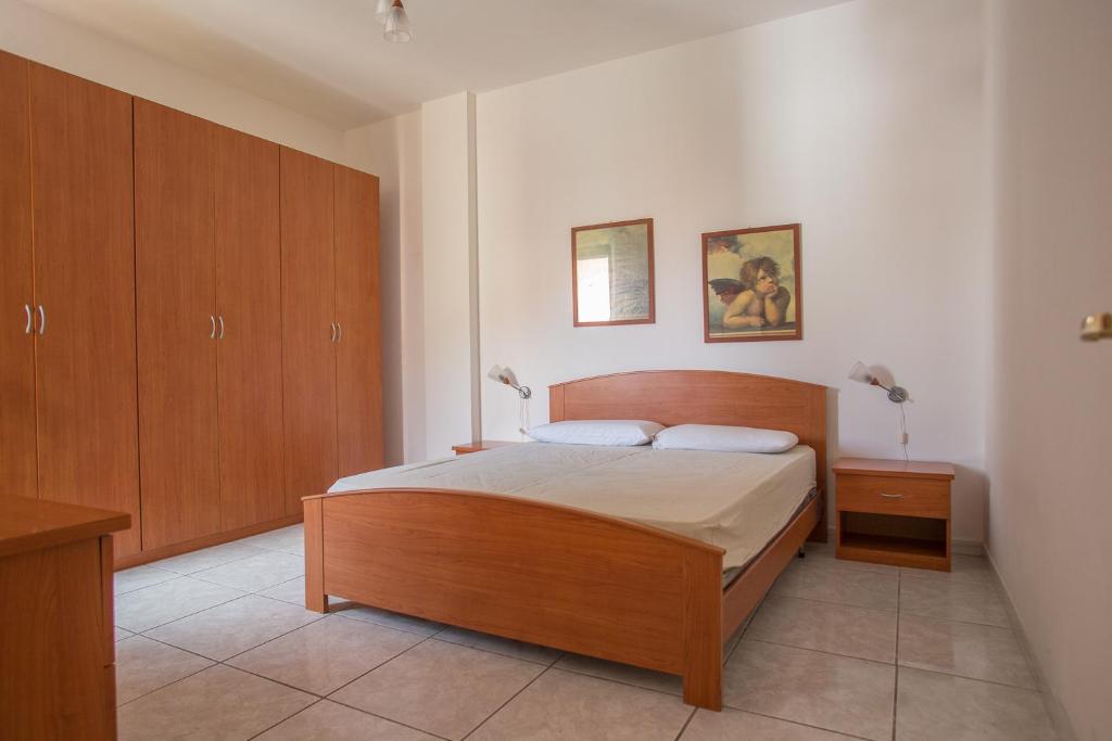 ガリポリにあるAppartamento Baia Bluのベッドルーム(ベッド1台、木製キャビネット付)