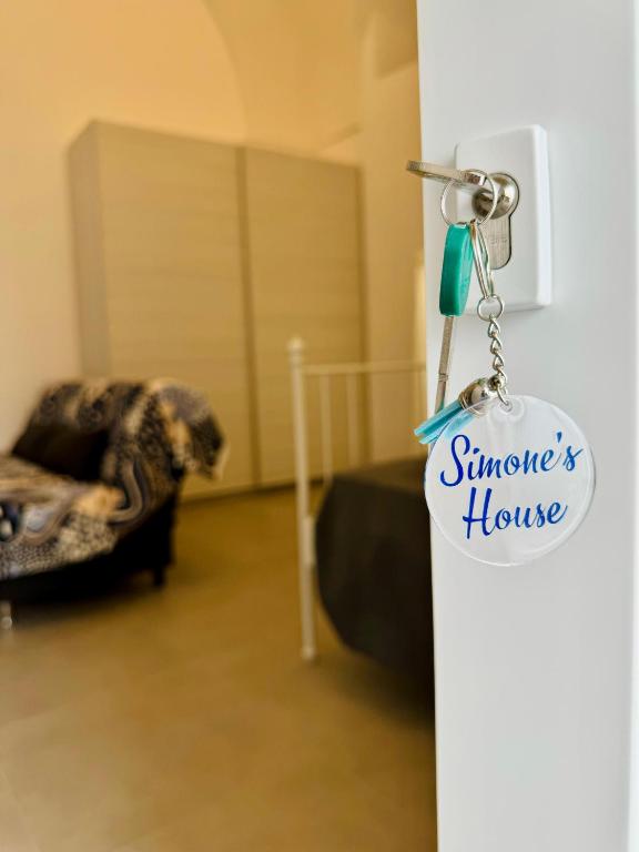 a key chain hanging from a door in a living room at Simone's House in Tuglie
