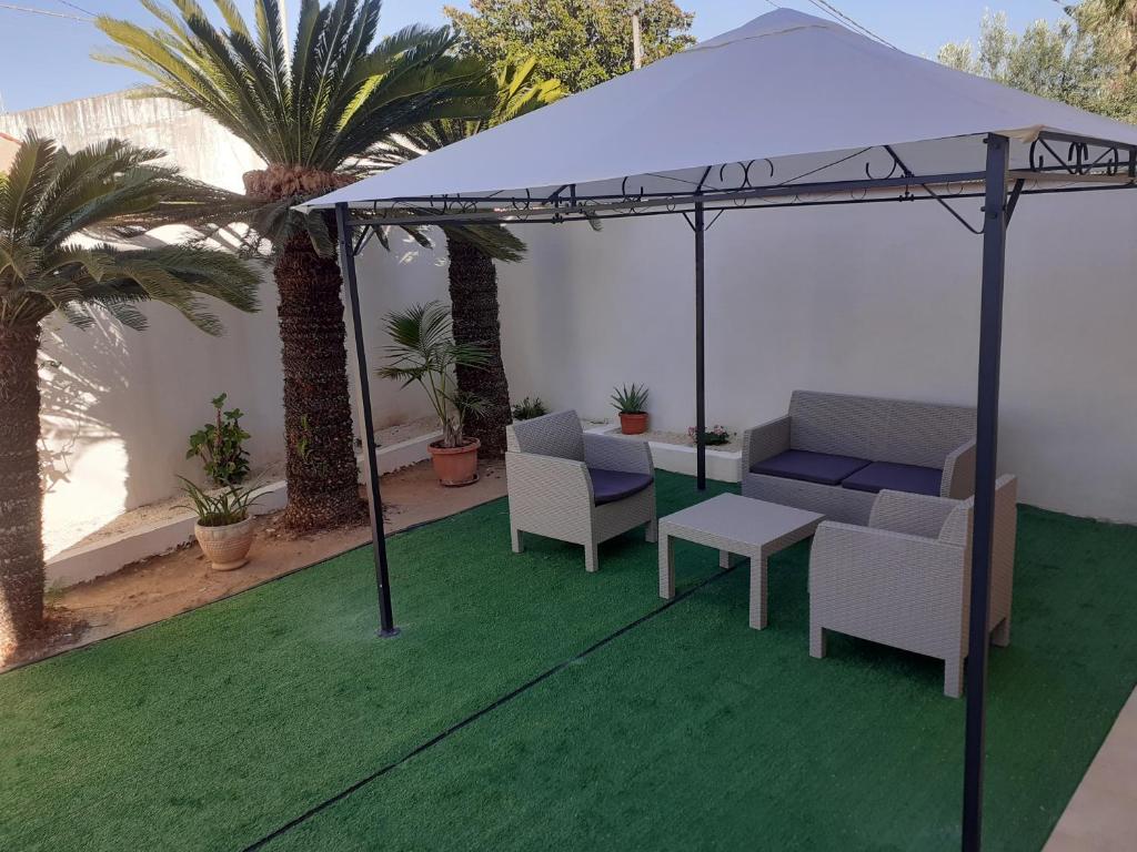 a gazebo with chairs and a table on a lawn at Casa di SaleRosa in Rilievo