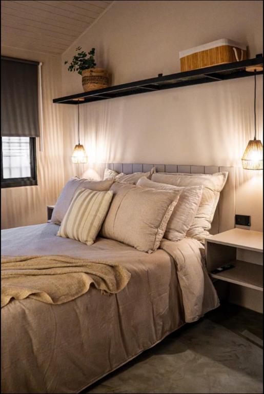 a bedroom with a large bed with two lights on it at Casa Mitho in Bogotá