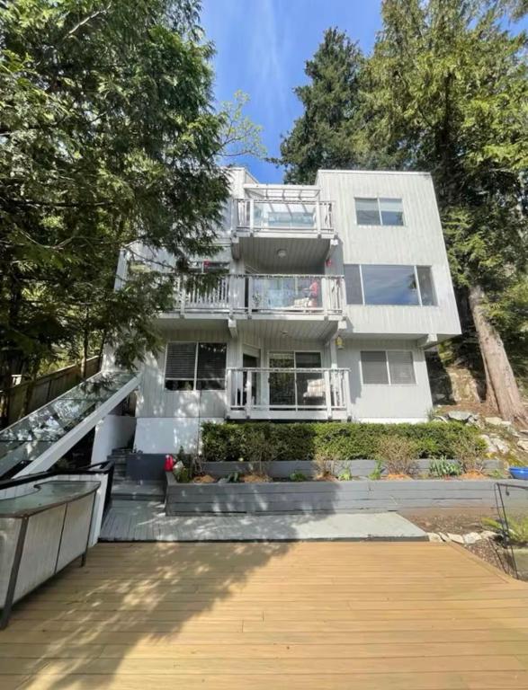 a large white building with a staircase in front of it at Cliff House in West Vancouver