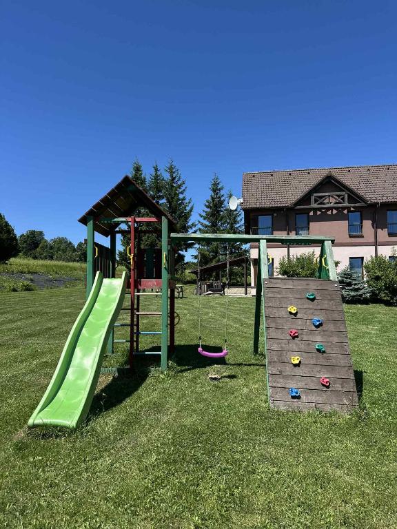 a playground with a slide and a play structure at Apartmány Na Rozcestí in Lomnice nad Popelkou