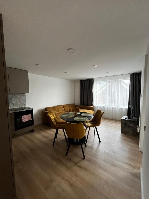 a living room with a table and chairs and a couch at Girios Horizontas - Mara in Trakai