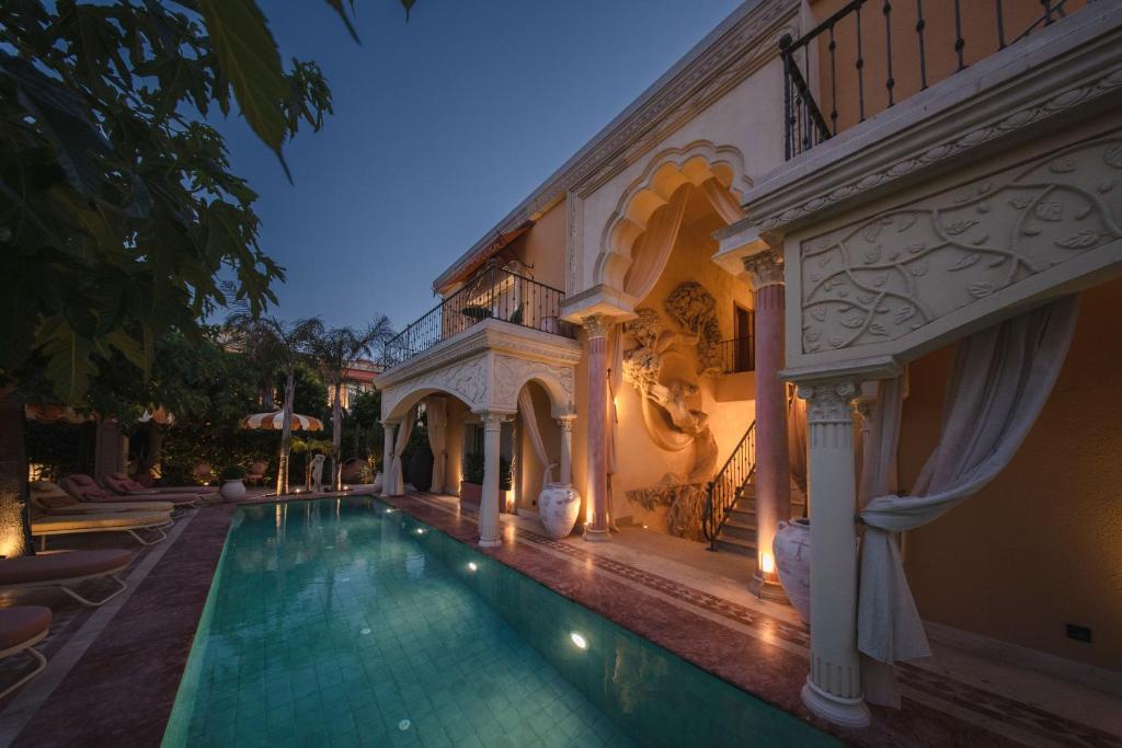 a swimming pool in a house with a building at Casa Fontana in Alacati