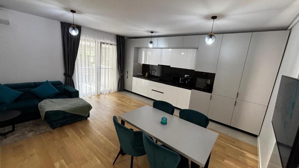 a living room with a table and a couch at Monarch Luxury Apartment in Timişoara