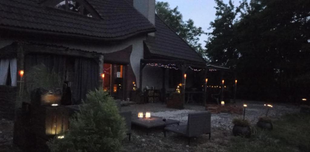 a house with a lit up patio at night at Chillout-House in Mińsk Mazowiecki