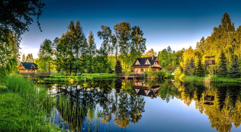 a house on the shore of a lake at Sucholand in Miedziana Góra