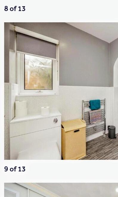 a bathroom with a white sink and a window at Studio Twenty One in Whitburn