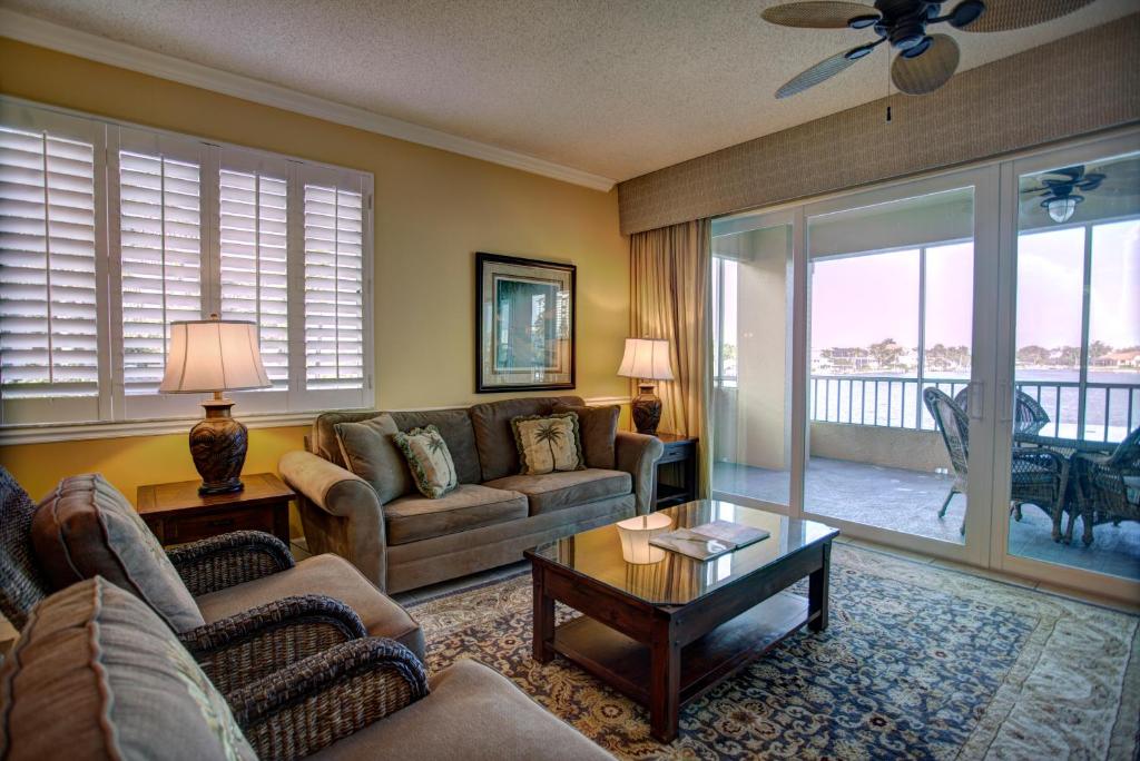 a living room with a couch and a table at Vanderbilt Beach Resort in Naples