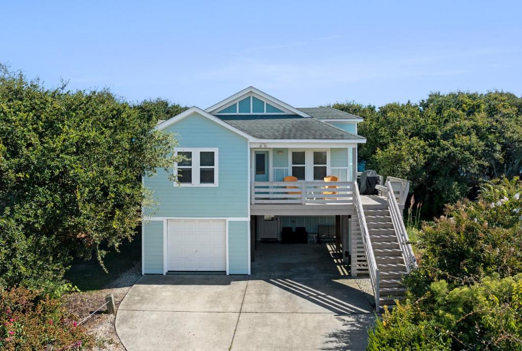 a blue house with a ramp leading up to it at CNU At The Beach in Kill Devil Hills