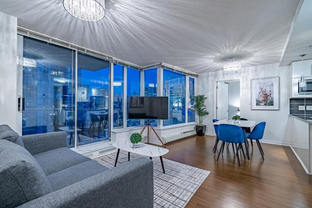 a living room with a couch and a table at Downtown Condo with Great City Views in Vancouver