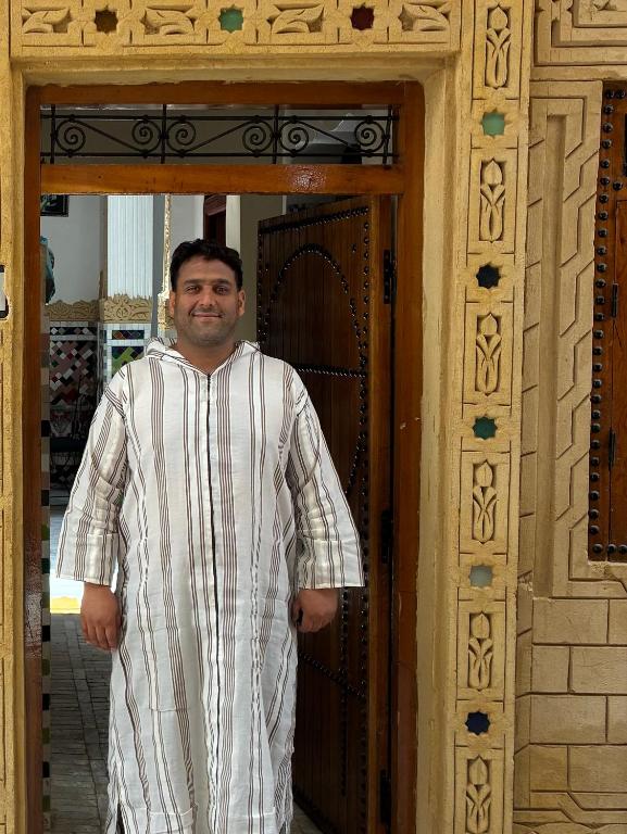 a man standing in front of a door at Riad Serendipity in Fès