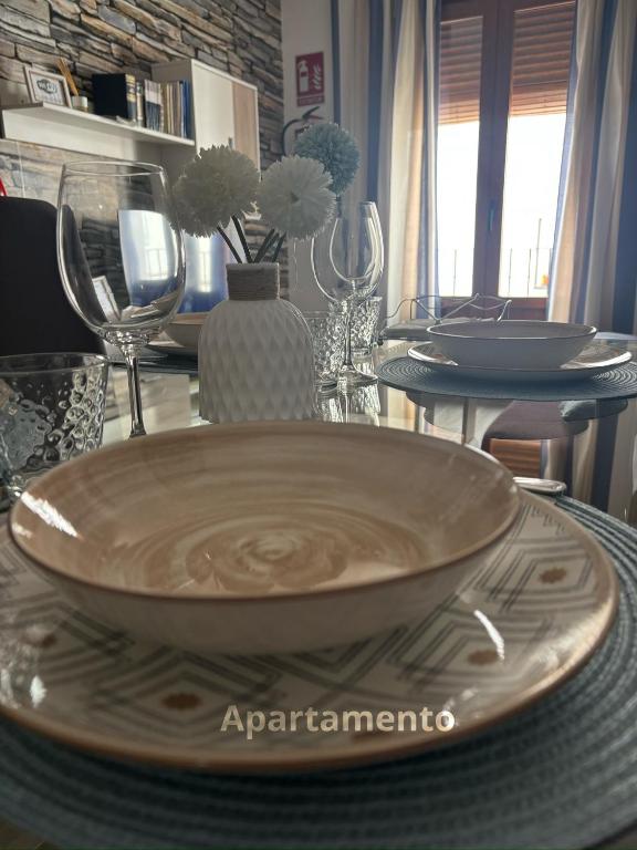 a table with plates and glasses on a table at Descanso de Dulcinea in Almagro