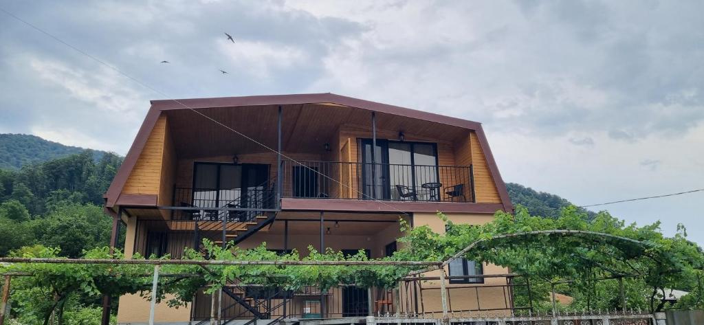 a building with a balcony on the side of it at Four Rooms in Lagodekhi