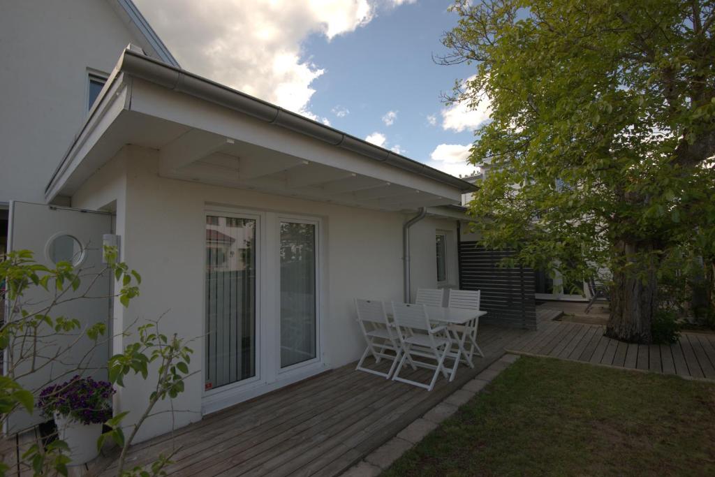 a patio with a table and chairs on a deck at Villa South Beach in Karlskrona