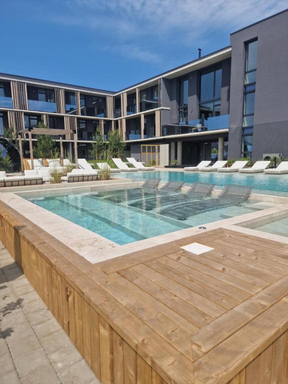 a swimming pool in front of a building at Seaside-Lithuania in Palanga