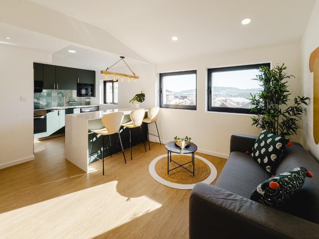 a living room and kitchen with a couch and a table at Chocolate House in Viana do Castelo