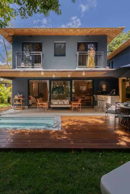 a house with a deck and a house at Refúgio com Pé na Areia in Mata de Sao Joao