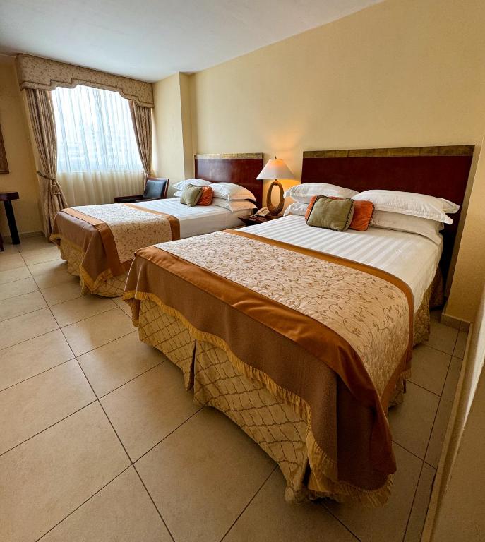 Postel nebo postele na pokoji v ubytování TOSCANA INN HOTEL
