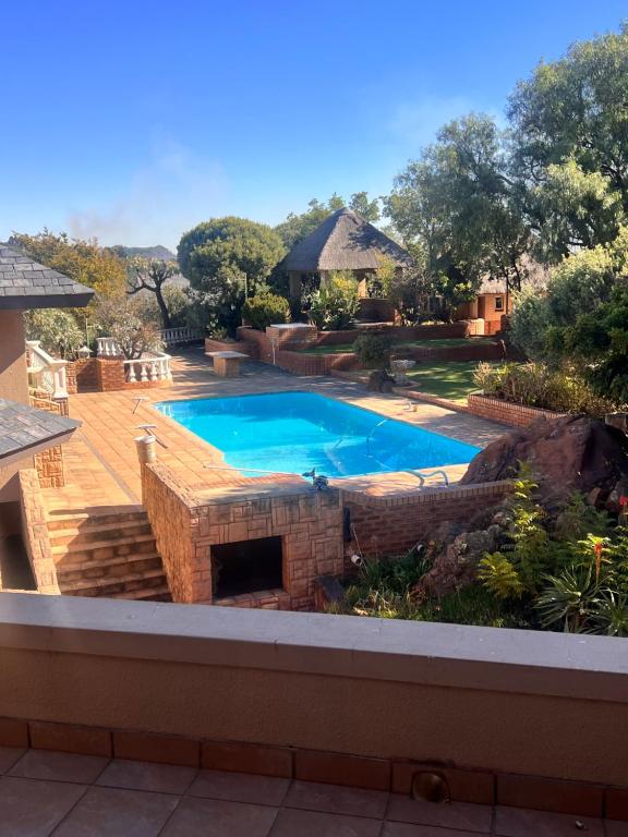 a swimming pool in a yard with a patio at Mountain View experience in Johannesburg