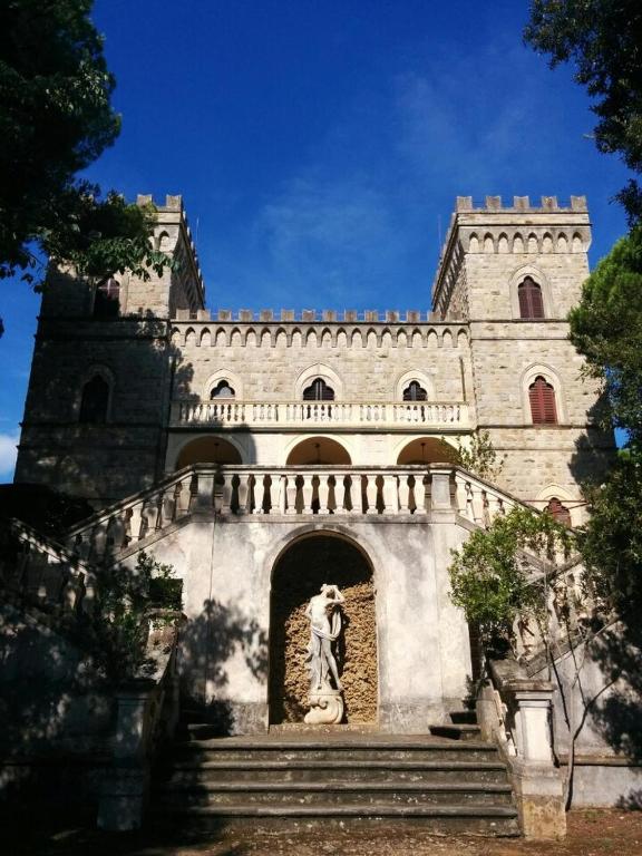 a building with a statue in front of it at Castello Bellariva with Swimming Pool and Tennis Court in Cavo