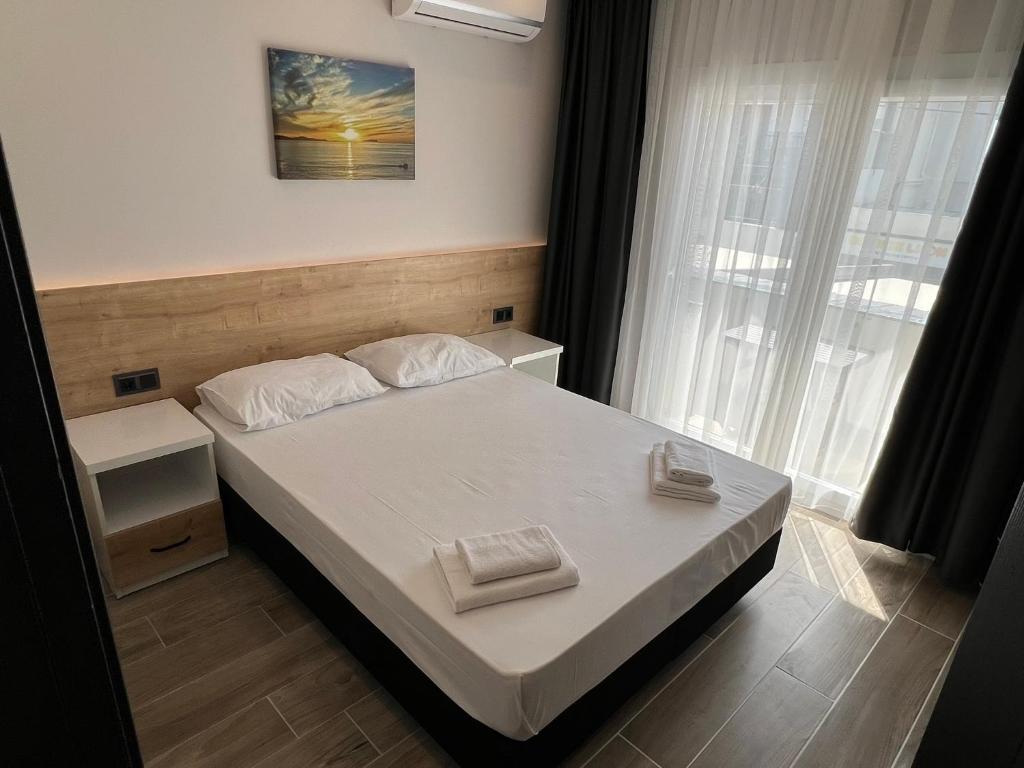 a small bedroom with a bed and a window at Ada Park Hotel in Kusadası