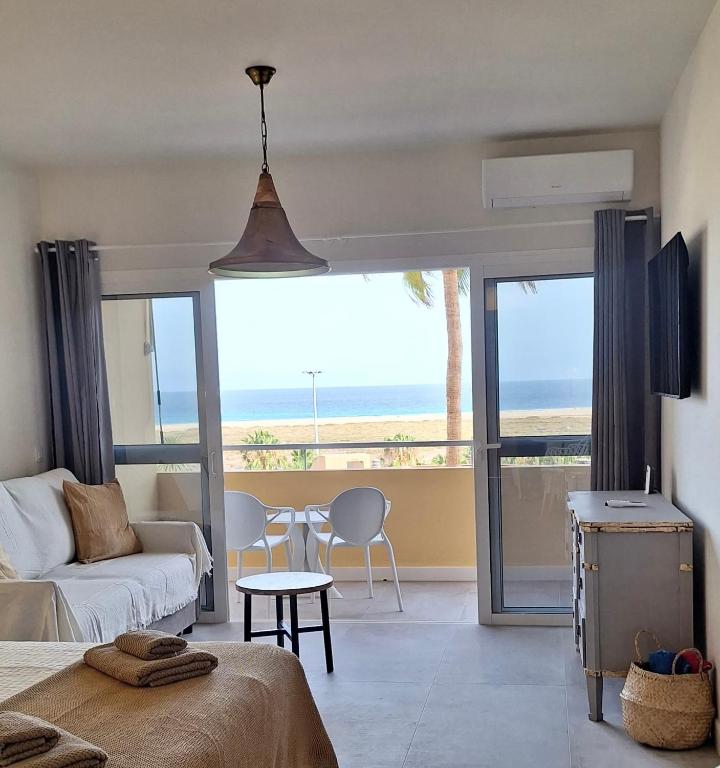 a bedroom with a bed and a view of the ocean at Sun&Ocean in Morro del Jable