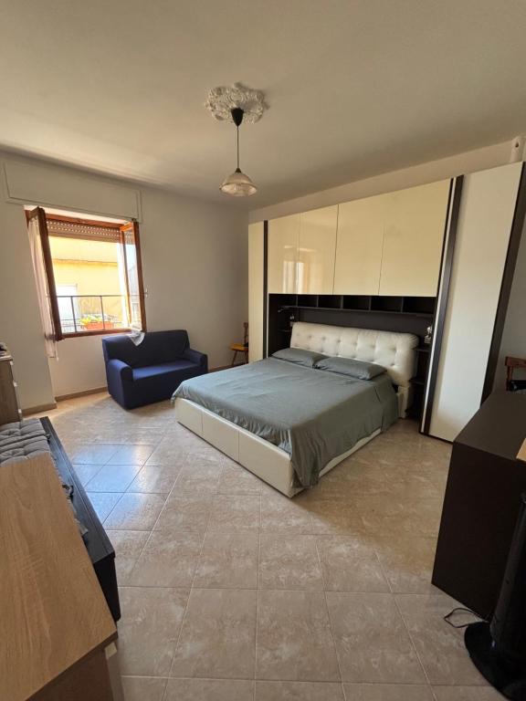 a bedroom with a bed and a blue couch at SebHouse in Alghero