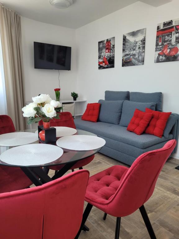 a living room with a couch and a table and chairs at Ela, Kedar 7 in Sveti Vlas