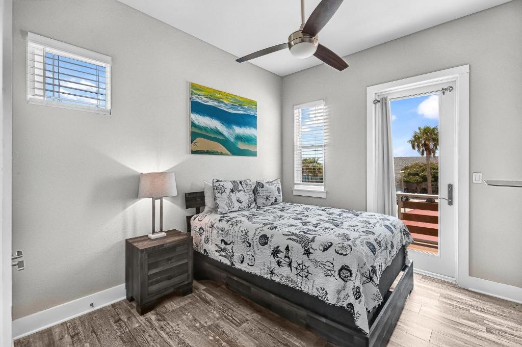 a bedroom with a bed and a window at Waterfront Condo with Rooftop + Pool + Boat Slips in Corpus Christi