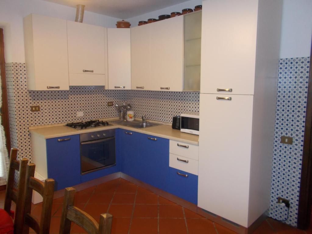 a kitchen with blue and white cabinets and a sink at Verdazzurro in Camaiore