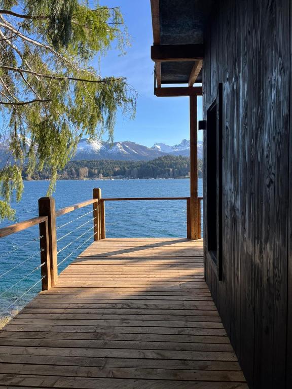 a wooden dock with a view of a body of water at Suite del muelle in San Carlos de Bariloche