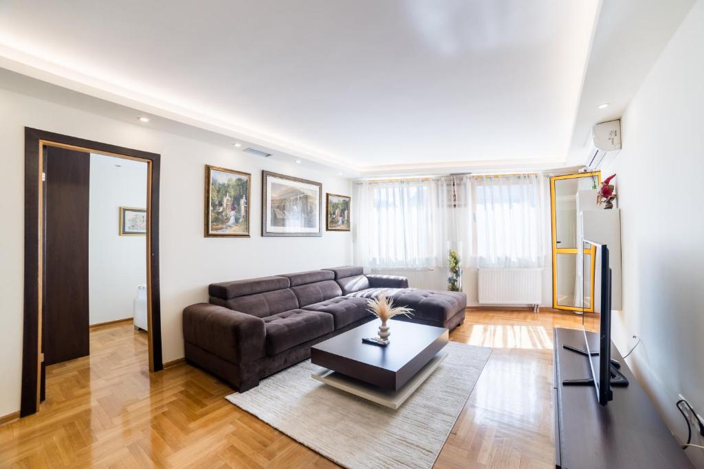 a living room with a couch and a table at Skenderija Skyline Luxury- 2BR Apartment with Garage and Balcony in Sarajevo