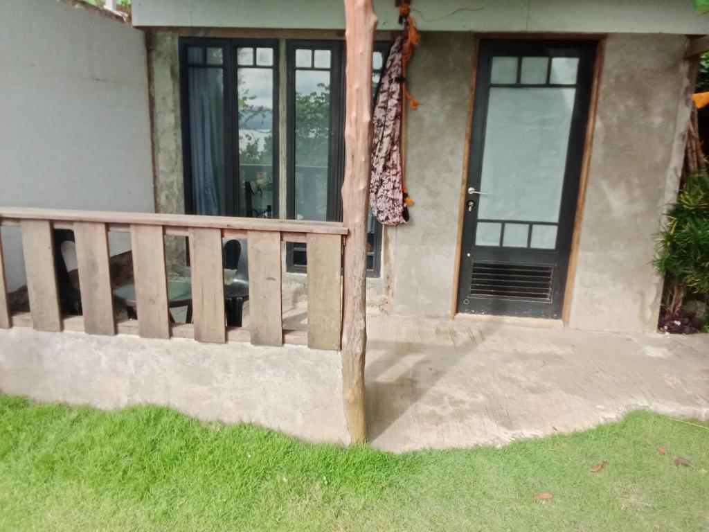 a house with a wooden fence and a door at El Nido Bayview in El Nido