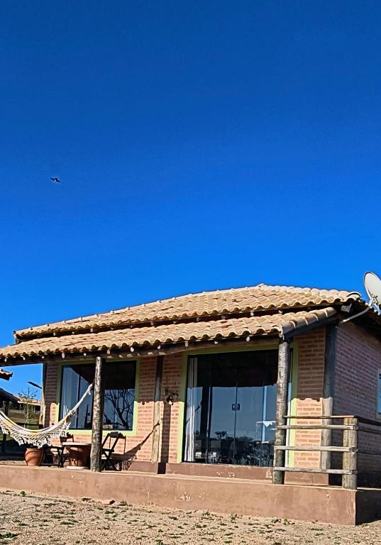 a building with a large window on top of it at Chalé estrela do cruzeiro in São Thomé das Letras