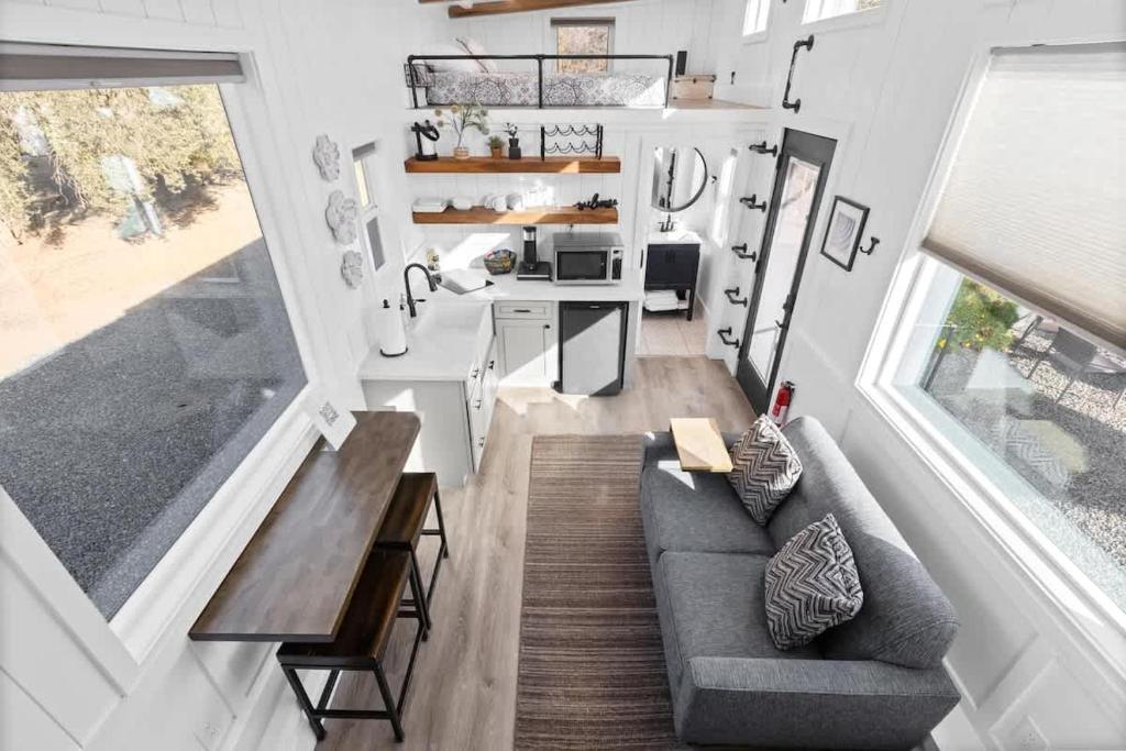 a small living room with a couch and a table at Tiny Home | Lewis Ranch 1 in Lindsay