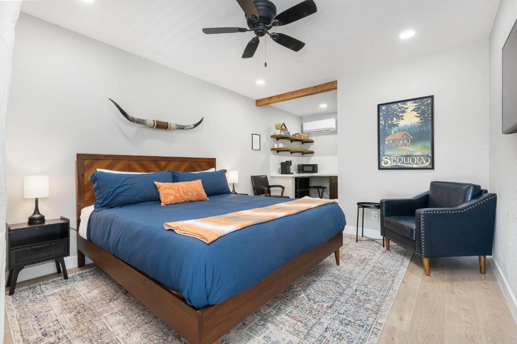 a bedroom with a blue bed and a chair at The Tokopah Sequoia Motel RM 1 in Three Rivers
