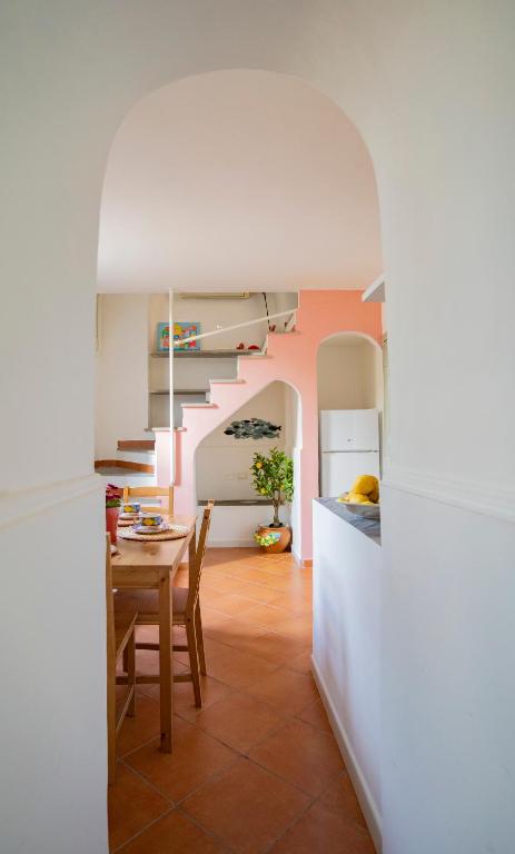 a kitchen with a table and a dining room at La Casa del Comandante in Procida