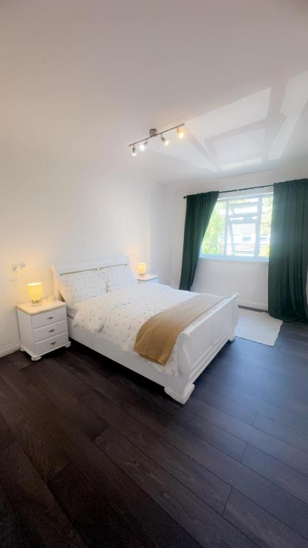 Hotel Nilly apartment Richmond Close Birmingham b20, a white bedroom with a large bed and a window at Nilly apartment Richmond Close Birmingham b20 in Birmingham