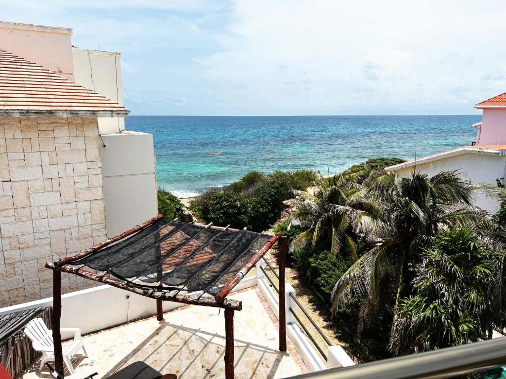 a view of the ocean from the balcony of a house at Suites paty de Suites Rocio in Isla Mujeres