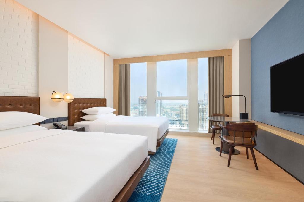 Postel nebo postele na pokoji v ubytování Four Points by Sheraton Rizhao